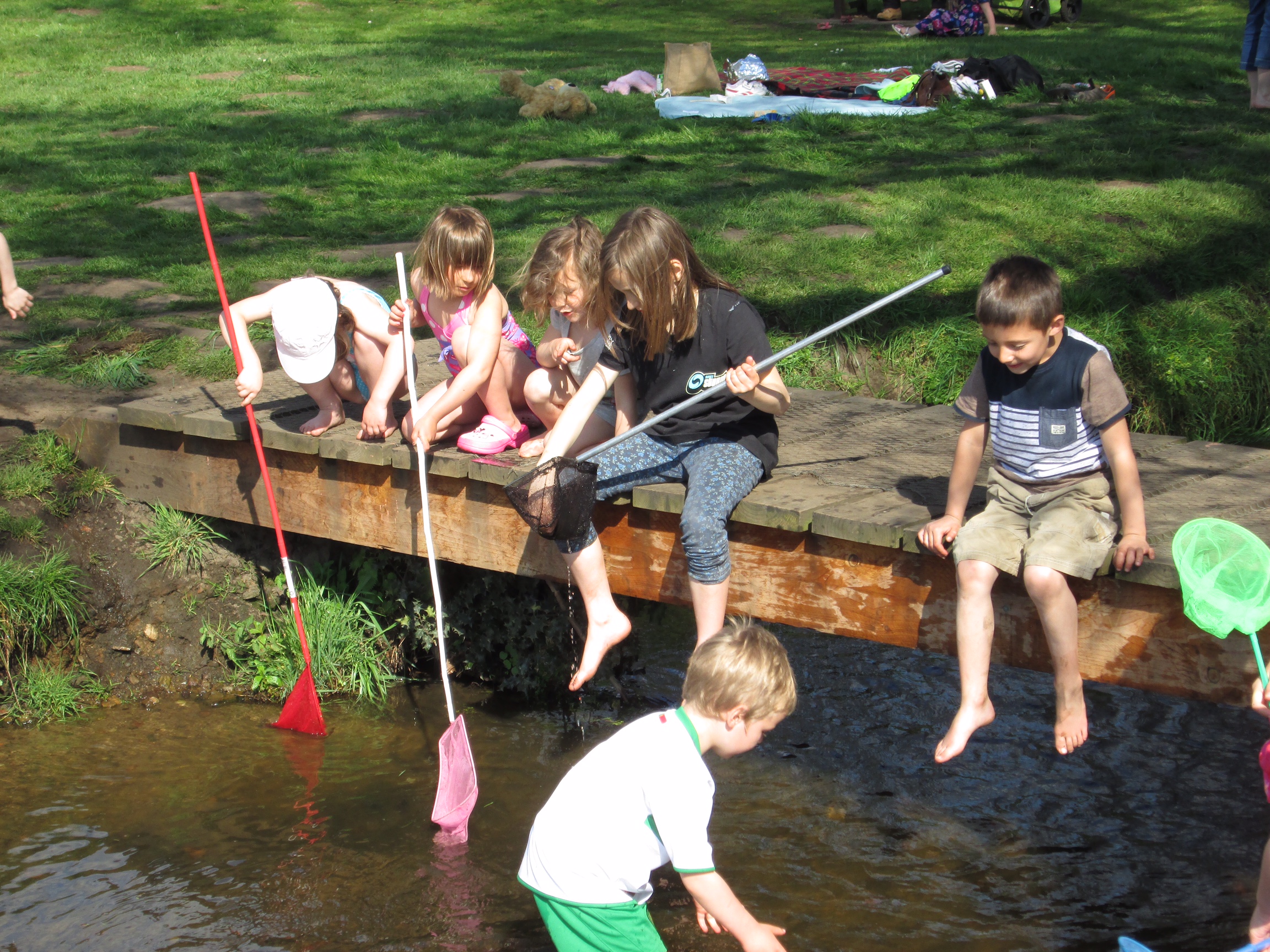 Bobby 2: Right to left sitting on the bridge: Sonny, Layla, Kyla. Grandchildren catching tiddlers at The Teddy Bears' Picnic.