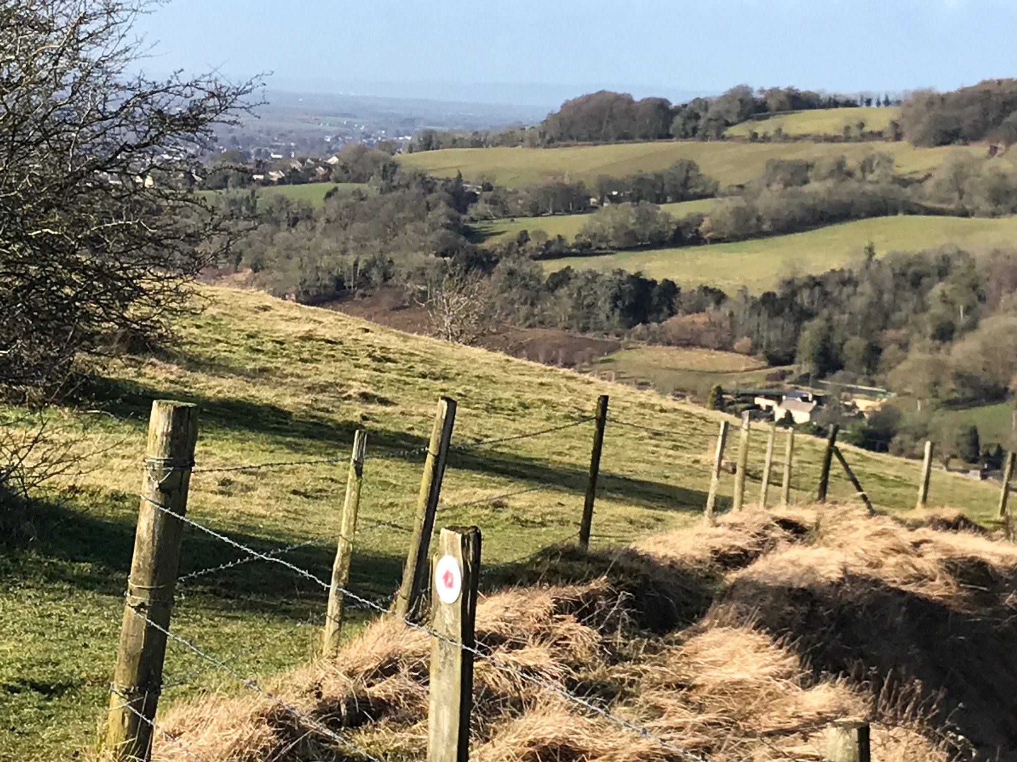 Cotswolds: Swifts Hill looking down on the Slad Valley. In the far distance across the Severn Valley to the Black mountains of Wales.