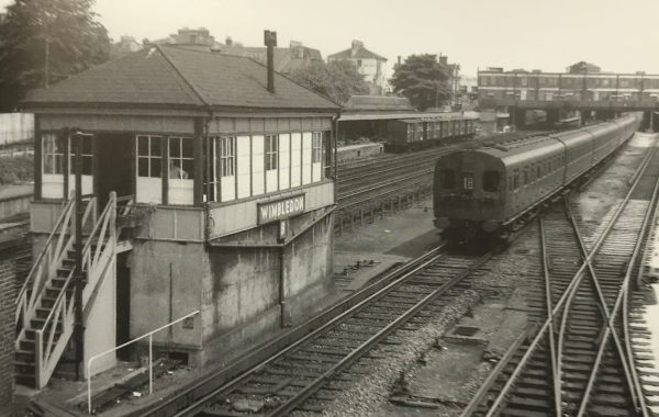 The Footbridge: 1957 again. A modern, for its day, 4-SUB electric train. The freight vans in the background once again at the “Milk Dock”.
