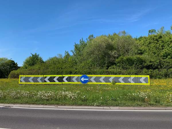 A roundabout with a glorious profusion of moon daisies and buttercups.