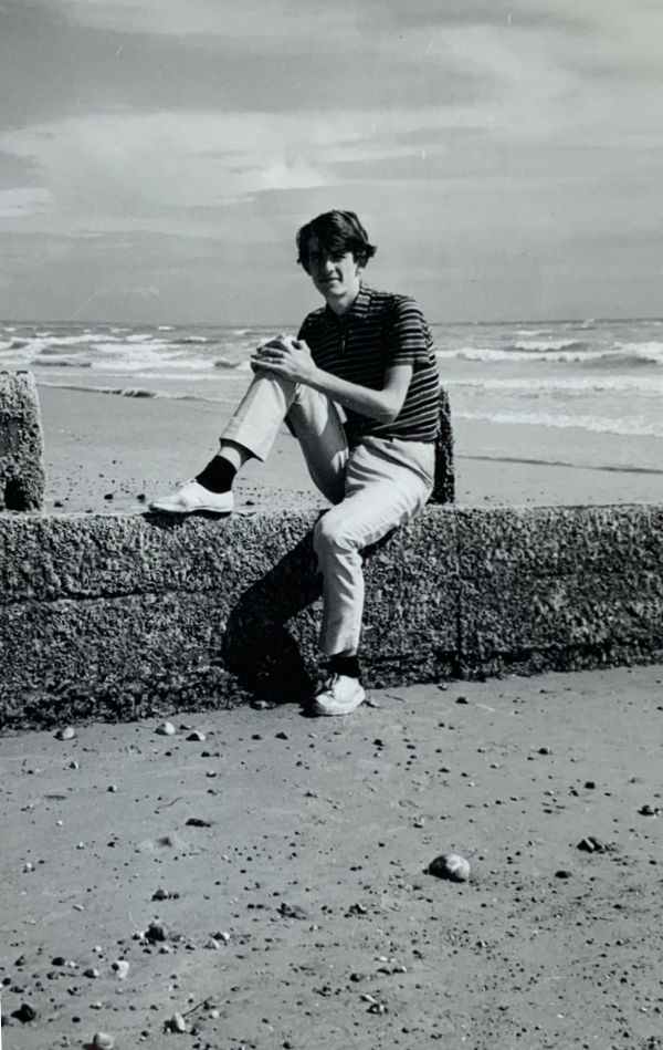 Bobby sat on a groyne on Lancing Beach, with the sea behind him.