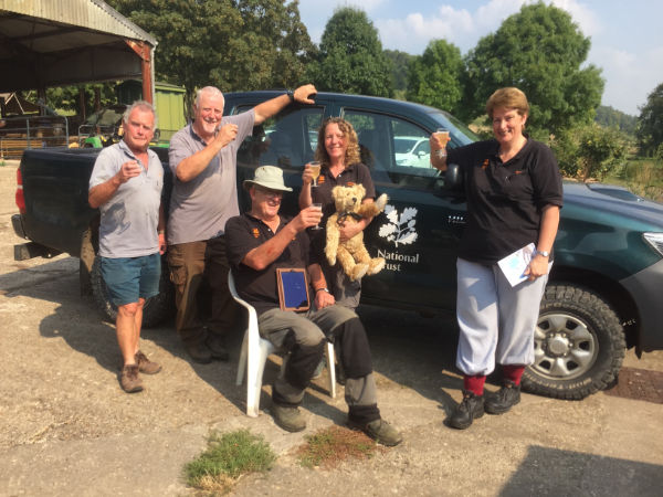 Bobby and Bertie posing with fellow National Trust volunteers by one of their 4x4 cars.