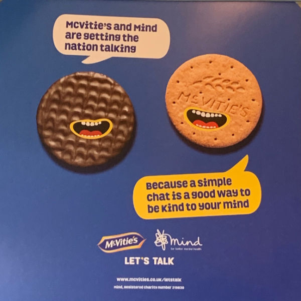Poster advertising McVities link with MIND for Mental Health. One biscuit is captioned "McVities and MIND are getting the Nation talking". The other is captioned "Because a simple chat is a good way to be kind to your mind".