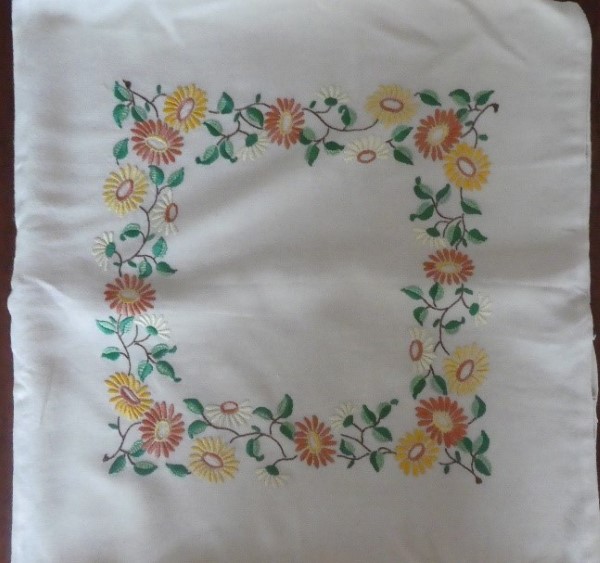 Embroidered flowers in a square pattern.