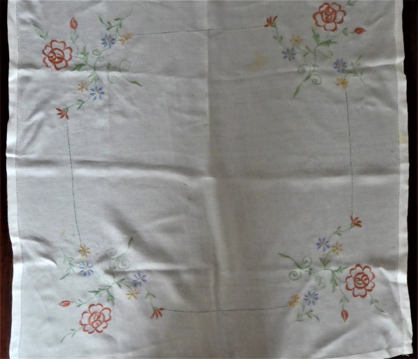 Embroidered flowers on table cloth.