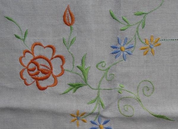 Embroidered flowers on table cloth.