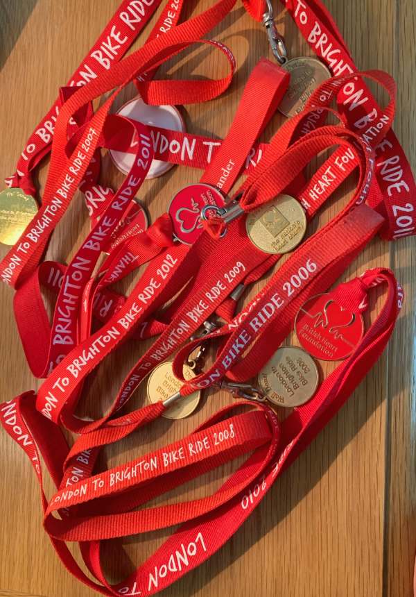 A collection of medals from several years for the London to Brighton Bike Ride. All on red lanyards.