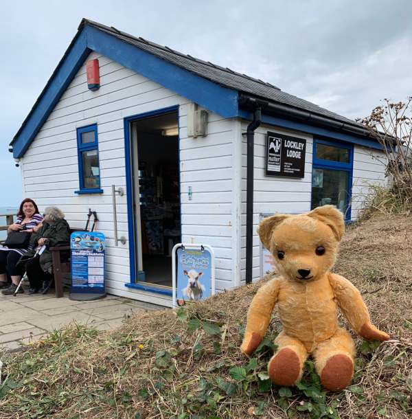 Eamonn sat outside Lockley Lodge - the Information Centre at Martin's Haven.