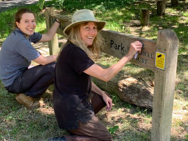 Rosie and Yasmin cleaning up the signs.