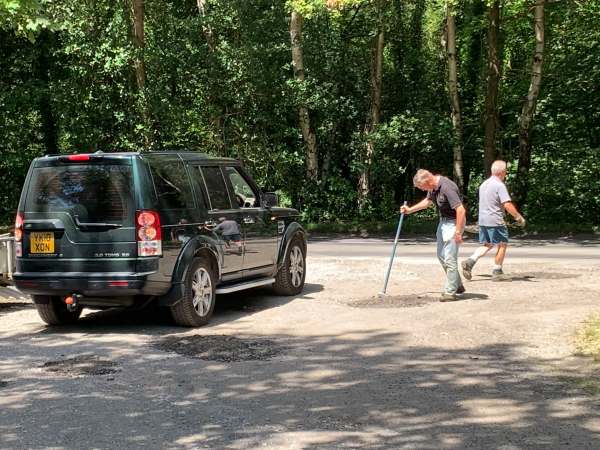 Mending the potholes. Using Ollie’s motor as a steam roller. Mark and Neil.