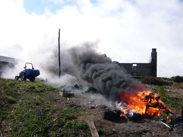 Burning the rubbish on a Monday. The tractor survived