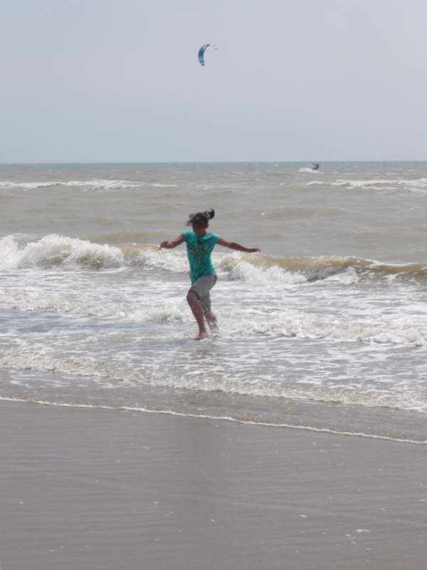 Jasmine playing in the water at Camber Sands.