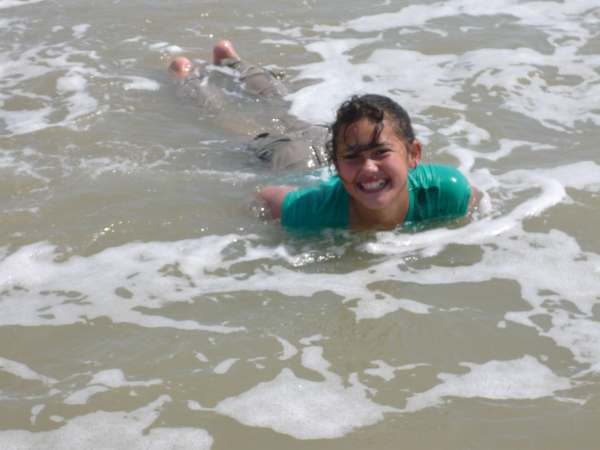 Jasmine lying face down in the shallow water - soaking wet!