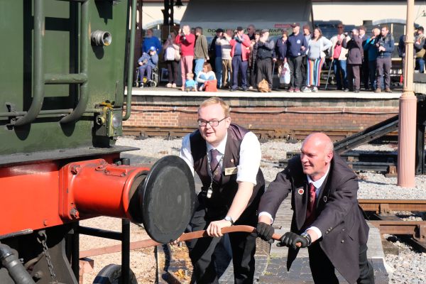 Staff pushing a locomotive on the turntable at Minehead.