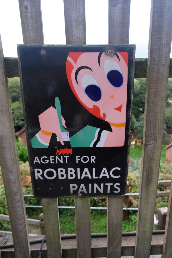 West Somerset Railway - Enamel Sign "Agent for Robbialac Paints" attached to a station fence.