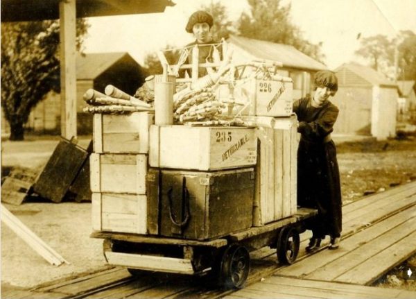 Fireworks loaded on a narrow guage railway truck by a couple of ladies - possibly in the Sutton Factory.