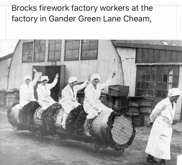 Brocks Fireworks factory workers at the factory in Gander Green Lane, Cheam. Picture of 5 ladies in front of a hut. 4 of them are being pulled on some sort of trolley by the fifth.