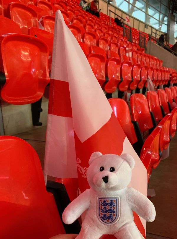 Ellen (a white bear with the England logo on her chest) and a free England flag in the seats at a near-empty Wembley Stadium.