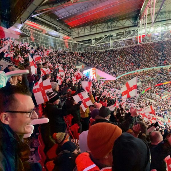 Enthusiastic fans at a packed Wembley Stadium.