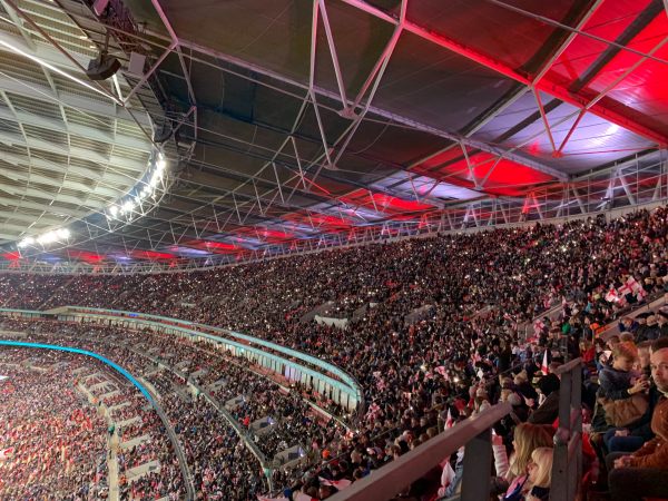 Fans of all ages supporting the Lionesses at a packed Wembley Stadium.