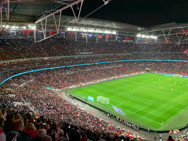 Fans with their phone lights on supporting the Lionesses at a packed Wembley Stadium.
