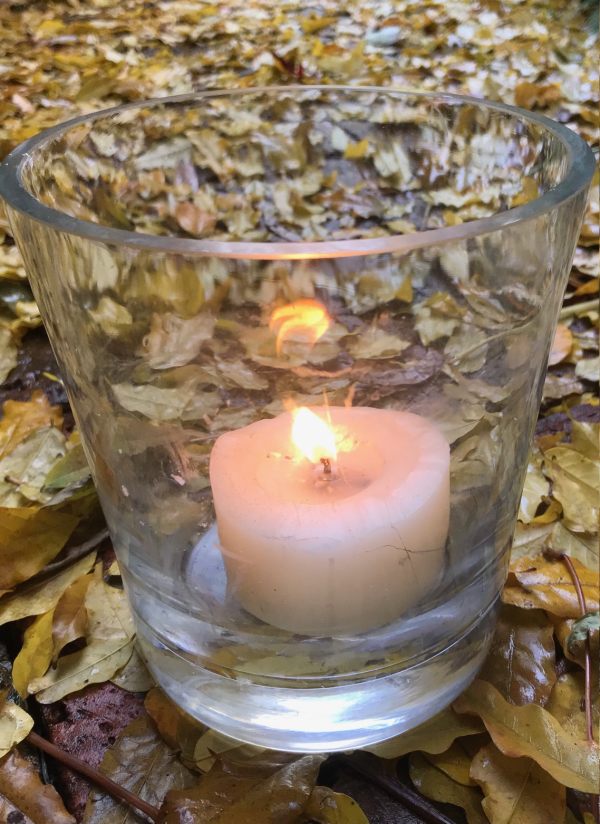 A candle lit for Diddley amongst the autumn leaves in Abinger Roughs.