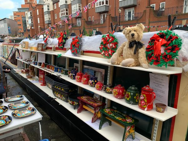 Bertie sat on the shelving of the "Canal Art by Julie" boat at the Birmingham Floating Christmas Market.