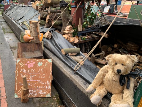 Bertie on the gunwhales of the Paw Print Brand Wood Crafts boat.