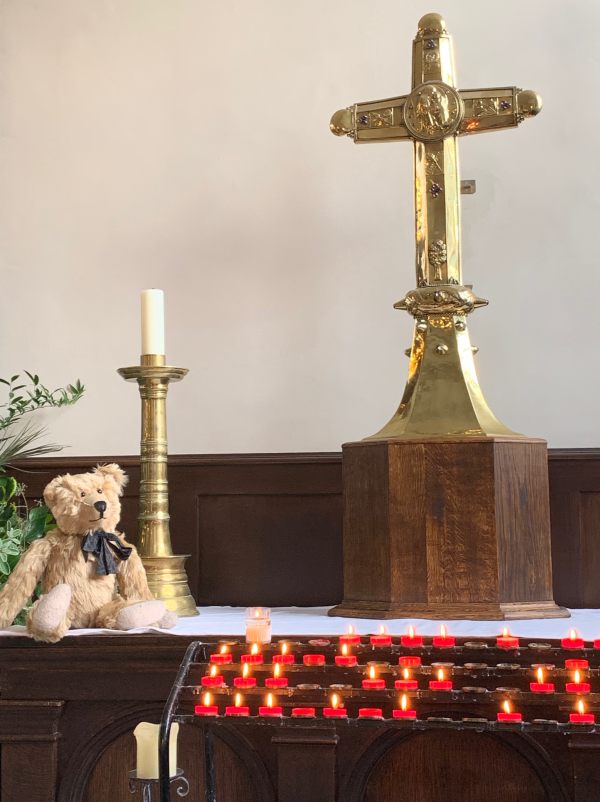 Bertie with a candle lit for Diddley in Birmingham Cathedral.