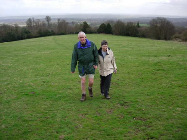 Bobby & Diddley walking up a steep, grassy hill.