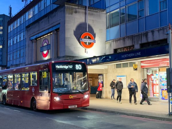 A No 80 bus heading to Hackridge outside the ultra-modern concrete structure of Morden Underground Station.