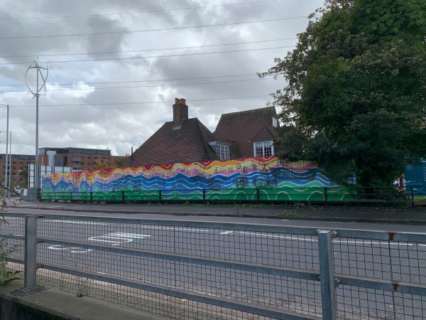 Colourful hoardings on the other side of the road.