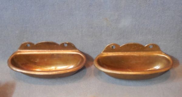 A pair of brass-effect cinema ashtrays.