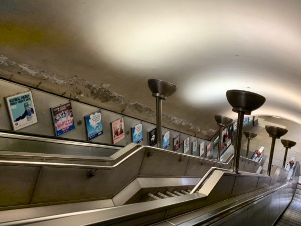 Escalators at Colliers Wood, showing the damp coming through the walls.