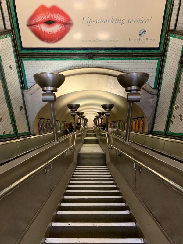 Escalators, stairs, tiles and uplighters at Clapham South.