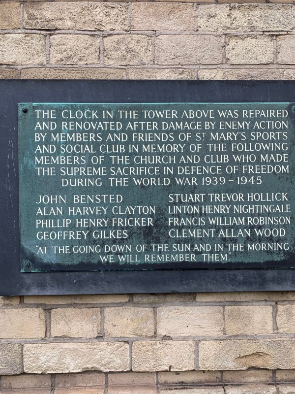 Memorial plaque on St Mary and St John the Divine wall referring to the renovations to the clock following bomb damage during the war.