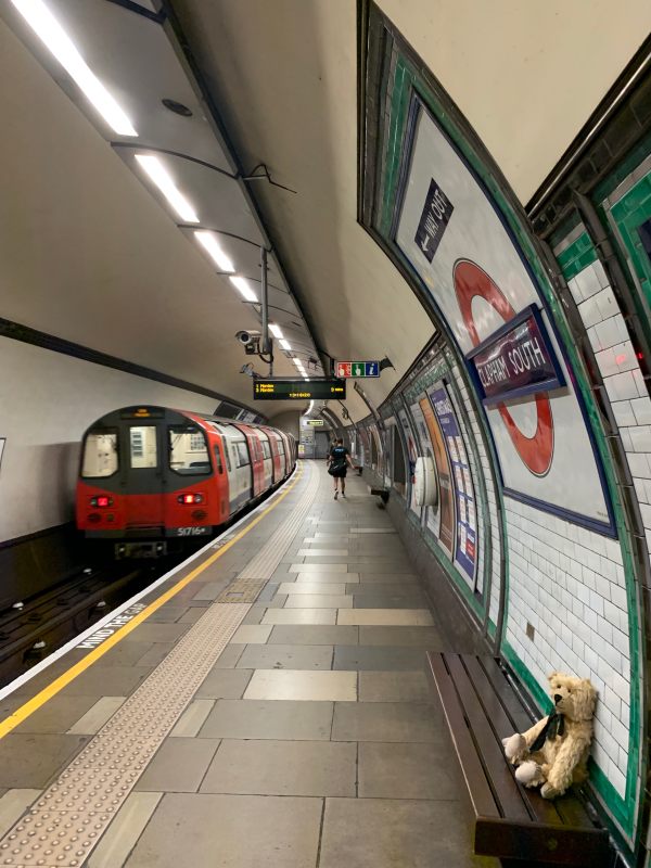 Bertie sat on a bench at Clapham South station as a tube train approaches the platform.