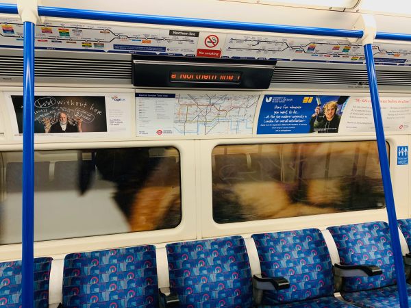 Advertising posters either side of the London Underground map.