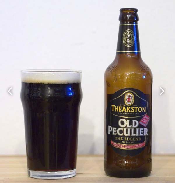 A pint glass and a bottle of Theakston Old Peculier.