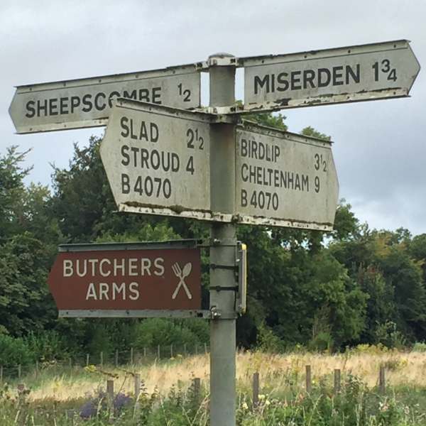 Signpost showing (amongst other places) Miserden to the right, Sheepscombe and the Butcher's Arms to the left.