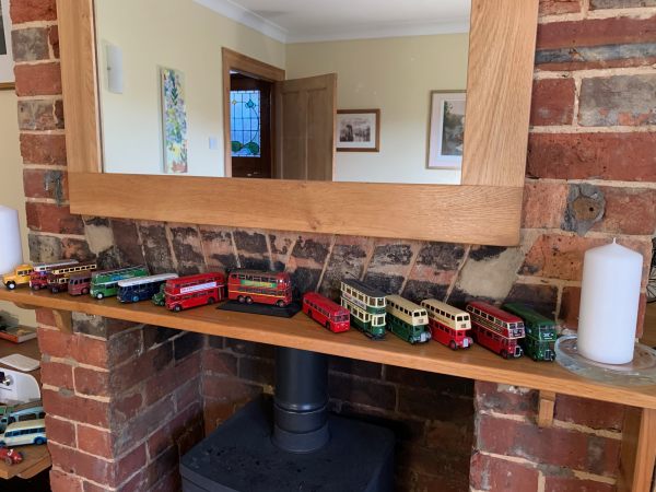 A mantlepiece displaying model buses.