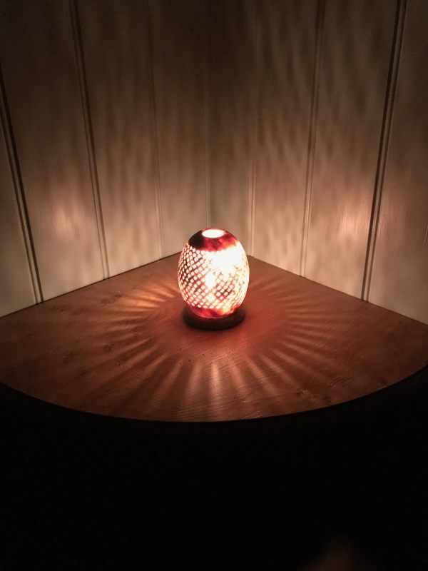 A lit candle for Diddley, on a corner table.