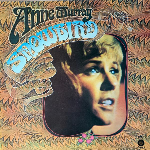 Album Cover Anne Murray - "Snowbird". A picture of her face within a patterned framing.