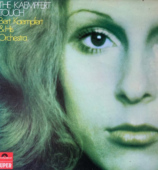 Album cover - "The Kaempfert Touch - Bert Kaempfert and his Orchestra". Picture of the left side of a lady's face, with blond hair cascading down.