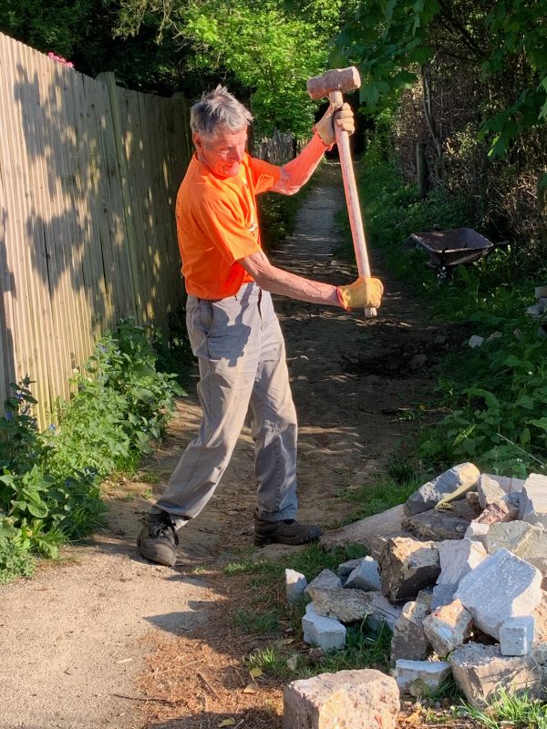 Mattock Mike (with a sledgehammer breaking up concrete).