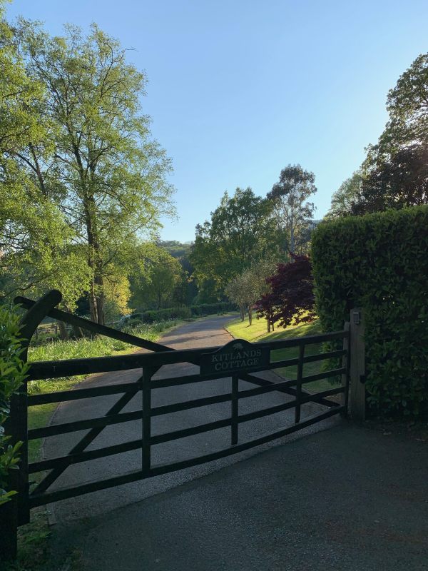 Stylish low wooden gate across the entrance to Kitlands Estate.