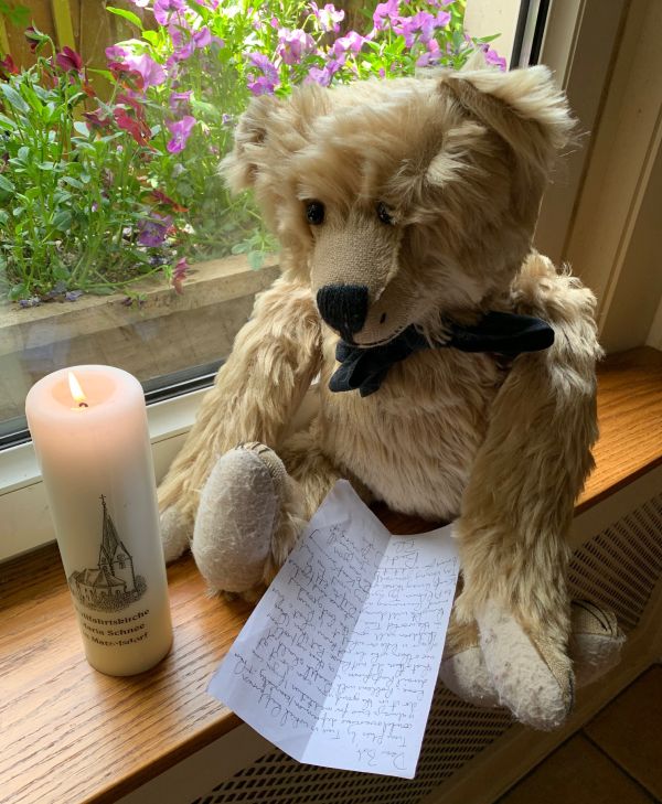 Lighting a Candle to Diddley: Bertie holding the letter sat on the windowsill with a lit candle.