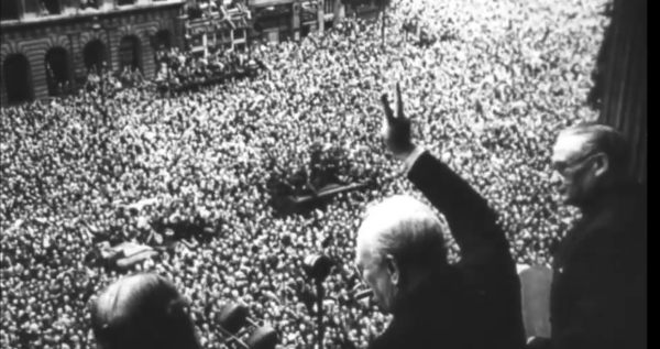 Photograph of VE Day parade with his characteristic V Sign.