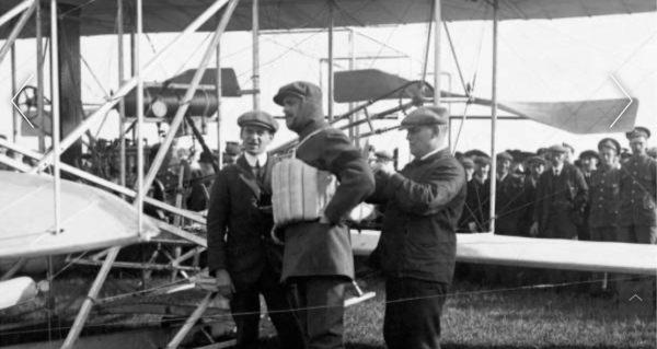 Charles Rolls being fitted with a primitive life jacket.