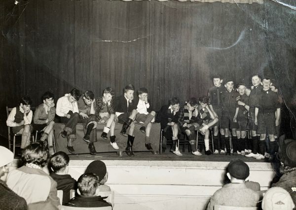 Bobby and some of the scouts performing a sketch on stage.